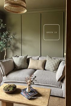 a living room filled with furniture and a potted plant on top of a wooden table