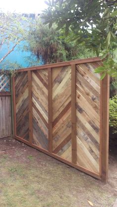 a fence made out of wooden boards in the yard