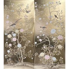 an open book with flowers and birds on it's cover, in gold foil