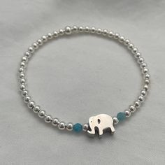 Embodying the sacred symbol of Hindu and Buddhist religions, elephants exude loyalty, power, wisdom, and fertility. Let this bracelet be a daily reminder of these admirable qualities. Create your own of a kind bracelet stack by mixing and matching from our collection! Details: 3mm quality sterling silver beads 7mm x 10mm elephant charm 14kt gold fill & sterling silver beads manufactured in the USA Beaded by hand on durable high performance elastic for a gentle stretch, making it effortless to slide on and off your wrist Pairs seamlessly with any bracelet stack How to figure out your wrist size: To ensure the perfect fit, wrap a flexible measuring tape snuggly around your wrist bone. Note the measurement in inches or centimeters, and then add half an inch for a comfortable fit. (example. if Silver Spiritual Stretch Bracelet Stackable, Spiritual Nickel-free Beaded Bangle Bracelets, Sterling Silver Bracelets With 8mm Beads For Gift, Hand-strung Silver Friendship Bracelets As Gift, Spiritual Sterling Silver Charm Bracelet For Friendship, Sterling Silver 8mm Beads Bracelet As Gift, Silver Hand-strung Friendship Bracelet As Gift, Spiritual Silver Beads Bracelet As Gift, Spiritual Silver Beads Bracelets For Everyday