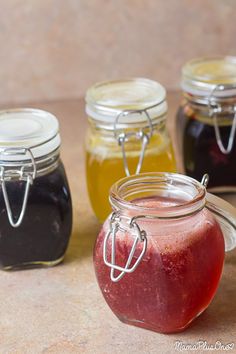 four jars filled with different types of liquid