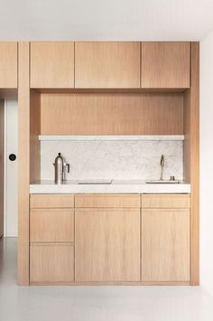 a kitchen with wooden cabinets and white counter tops