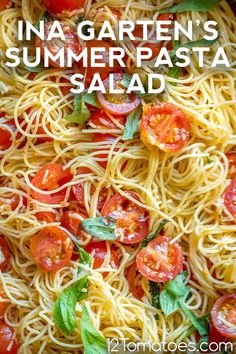 pasta with tomatoes and basil on top, in a white bowl text overlay reads ina garten's summer pasta salad