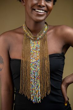 Unique African Maasai Handcrafted Beaded Necklace with an Elegant Look and Brilliant Finish. Color - Copper and Mixed Color Beads. Size - Adjustable Width. Length (Downwards) - 13.5 Inches / 35 cm. **GET FREE SHIPPING FOR ADDITIONAL ITEMS PURCHASED. Yes, Buy Multiple Items and pay shipping for 1 item only- The rest ships Free. (No Limits on the number of Multiple items). With a faster delivery time of 3 days via DHLExpress, Worldwide. Ordinary/Standard Shipping also available upon request. We Cu Bohemian Gold Choker With Colorful Beads, Adjustable Beaded Chain Necklaces For Festive Occasions, Adjustable Beaded Necklaces For Festive Occasions, Traditional Beaded Chain Bib Necklace For Festival, Traditional Multicolor Jewelry With Gold Beads, Bohemian Beaded Chain Beads For Festive Occasions, Bohemian Beaded Chain For Festive Occasions, Adjustable Multicolor Necklace With Gold Beads, Bohemian Gold Necklace With Polished Beads