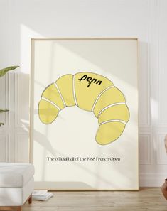 a framed poster with the words popin and a yellow croissant on it