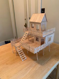 a house made out of wood sitting on top of a table