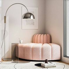 a living room with a pink couch and white rug on the floor next to a window