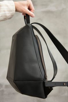 Comfortable leather backpack. Special and unique shape, a convenient construction is closed of a metal zipper-lock. Leather's outer distinctive feature - vintage look. It takes bends, creases or scratches if you hook on something. Scratches are easy to remove by rubbing the place with some soft fabric or even a finger. The leather is of high quality, keeps shape perfectly. This city-style travel bag is the perfect size for any of your daily essentials. In the middle of the backpack there is a po Modern Backpack With Zipper Pocket, Modern Rectangular Backpack With Zipper Closure, Modern Softback Backpack With Zipper Closure, Modern Black Leather Backpack With Zipper Closure, Modern Backpack With Adjustable Strap, Modern Softback Backpack, Modern Softback School Backpack, Modern Leather Shoulder Backpack With Zipper, Modern Leather Backpack With Zipper Closure