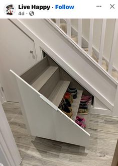 an under the stairs shoe rack is open to show shoes in it's bottom drawer