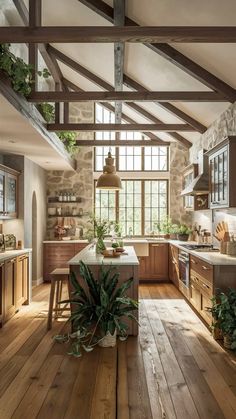 a kitchen with wooden floors and lots of windows