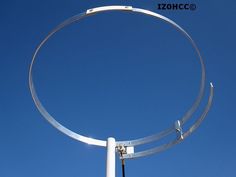 a metal pole with a circular object attached to it's side against a blue sky