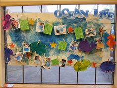 the ocean life bulletin board is decorated with pictures and handwritten words on clothes pins