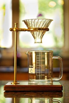 a glass measuring cup sitting on top of a wooden table