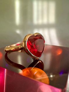 With its playful, symbolic vibe and juicy red color, this striking ring from our Simplicity Collection is a perfect addition to any modern collection. Large red heart shaped ruby is encased in meticulously hand finished band. This stunning ring will make a fun alternative to a traditional cocktail ring. Available for immediate shipping: Ruby 11mm x 12mm Set in 9K rose gold Size: 17.5 Please contact us for sizing options 14k Gold Ruby Ring For Valentine's Day Gift, Red 14k Gold Heart Promise Ring, 14k Gold Red Heart Ring For Promise, Red Heart Shaped Ruby Promise Ring, Red Heart Ring For Proposal In Fine Jewelry Style, Red Heart Promise Ring Fine Jewelry, Valentine's Day Gift Ruby Ring In 14k Gold, Valentine's Day Rings With Polished Finish, Red 14k Gold Heart Ring For Promise