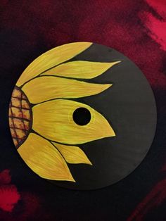 a painted sunflower on a black and red background