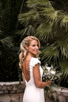 a woman in a wedding dress holding a bouquet