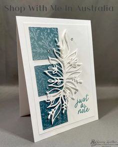 a white card with blue and green paper on it, featuring the words just not late