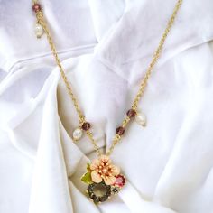 This Enamel Cherry Blossom Flower Crystal Necklace is expertly crafted with delicate details and made to last. The beautifully enameled cherry blossom flower design is adorned with sparkling crystals, adding a touch of elegance to any outfit. Perfect for nature lovers, this necklace is a timeless piece that will never go out of style. Collection: Garden Series Product Type: Necklace Material: 18k gold plating brass, enamel, pearl, crystal Charm Dimensions: Height: 22 mm, Width: 24 mm Necklace le Charms Candy, Cherry Blossom Flower, Flower Crystal, Cherry Blossom Flowers, Pearl Crystal, Butterfly Brooch, Hydrangea Flower, Plum Blossom, Crystal Charm