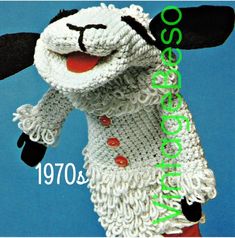 a crocheted sheep wearing a scarf and hat with the number 1970 written on it