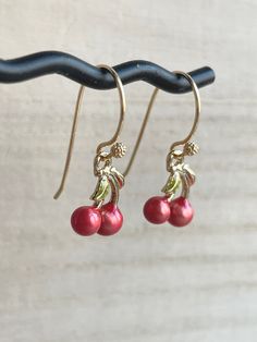 These dainty and cute cherry earrings are made of the following: (1) Gold plated red and green enamel cherry charm (12 x 10mm) (2) Gold plated or 14KGF earring hooks ✏️ Please choose your desired earring hooks 🍒EARRINGS 🍒 Clip On Hoops → https://www.etsy.com/listing/905698702 Threader -> https://www.etsy.com/listing/602107194 🍒NECKLACE 🍒 -> https://www.etsy.com/listing/615948435 【ADDITIONAL QUANTITY】 Kindly convo us if you require additional quantity and we will be happy to customize t Cute Round Red Jewelry, Cute Red Round Jewelry, Red Drop Pearl Earrings For Gift, Cherry Colored Earrings For Valentine's Day Gift, Cherry Color Earrings For Valentine's Day Gift, Cherry Earrings For Valentine's Day Gift, Red Hypoallergenic Dainty Earrings, Cherry Colored Round Earrings For Gift, Cherry Round Earrings For Gift