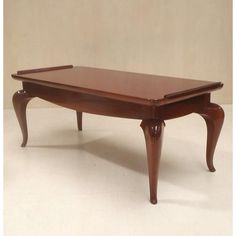 a wooden coffee table sitting on top of a white floor