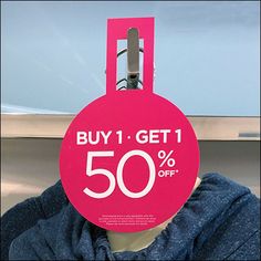 a pink sale tag with the words buy 1 get 1 50 % off on it