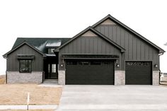 a large house with two garages in the front and one on the other side