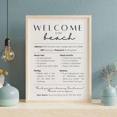 a welcome to the beach sign on a shelf next to vases and lamp bulbs