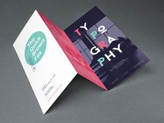 an open brochure is displayed on a gray surface with the words tygraph printed on it