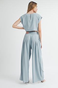 This Solid Crop Top & Pleated Wide Leg Pants set is a must-have for any formal occasion. With its simple and classic design, it offers an effortless yet elegant look. The short sleeve crop top and wide leg pants provide a comfortable fit, while the pleated details add a touch of sophistication. Perfect for any fashion-forward individual. Summer Workwear Crop Top With Short Sleeves, Chic Short Sleeve Pant Set For Summer, Fitted Cropped Wide Leg Pants For Work, Chic Cropped Sets For Workwear, Elegant Cropped Wide Leg Pants For Work, Chic Short Sleeve Pantsuit For Work, Chic Short Sleeve Workwear Pantsuit, Chic Cropped Pant Set For Summer, Elegant Cropped Wide Leg Pants