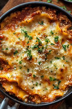 a skillet filled with lasagna sauce and parmesan cheese