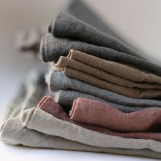 a stack of folded clothes sitting on top of a white table