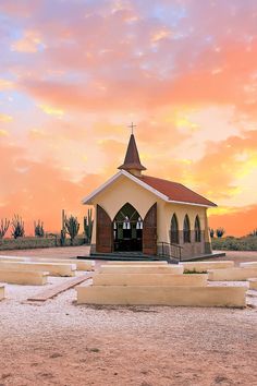 a small church sits in the middle of a desert