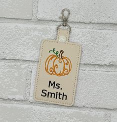 Pumpkin teacher ID holder,  this personalized badge holder has clear backing that holds an ID, business card, credit card, etc.  This personalized badge holder can clip to your lanyard, bag, purse, luggage, etc. with included metal clasp.  Handmade from ivory/cream faux leather vinyl with a clear vinyl backing that allows you to insert card/ID.  Snap will be ivory as pictured, if you want a different color please message me to confirm. If you would like a different color than pictured, please message me for availability. Personalization: Limit two lines, limit 8 letters per line. Size: Approximately 2.6" wide and 4 inches tall. Thank you for supporting my handmade, veteran owned small business. Rectangular Badge Holder With Id Window As Gift, Rectangular White Badge Holders As Gift, Customizable Multicolor Badge Holders For School, Rectangular Badge Holder With Id Window, Customizable Rectangular Badge Holders As Gifts, White Badge Holder With Key Clip For Personal Use, White Rectangular Badge Holders For Everyday Use, Customizable White Badge Holders For Personal Use, White Rectangular Badge Holder For Personal Use