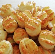 there is a plate full of bread rolls on the table