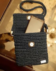 a cell phone in a crocheted purse