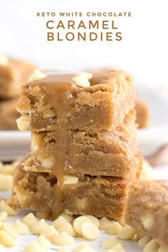 two pieces of caramel blondies stacked on top of each other with white chocolate chips