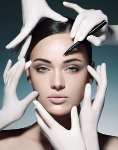 a woman wearing white gloves and holding her hands up to her face