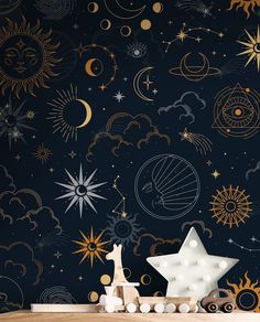 a wooden table topped with a toy horse next to a night sky wallpaper