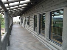 a wooden walkway between two buildings with windows