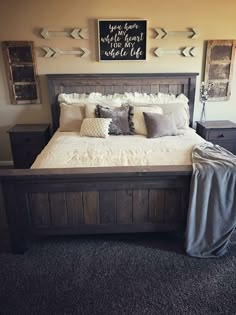 a bedroom with a bed, dressers and pictures on the wall