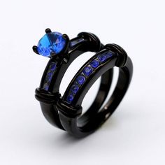 two black rings with blue stones on them