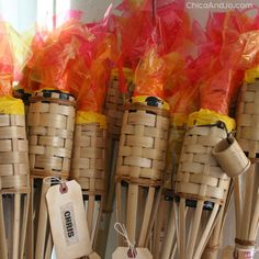 several bamboo sticks with orange and yellow ribbons on them are lined up next to each other