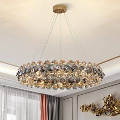 a chandelier hanging from the ceiling in a living room