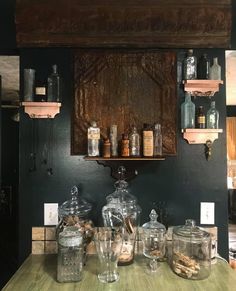 an old fashioned kitchen counter with jars and bottles on it