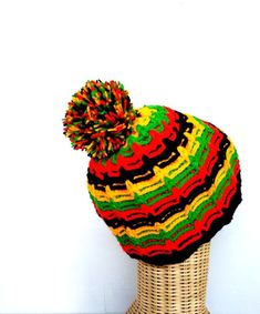 a multicolored hat sitting on top of a wicker basket