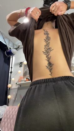 the back of a woman's body with flowers on it