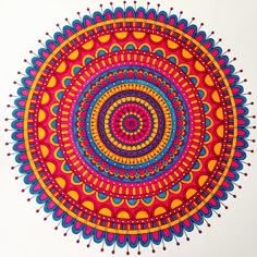 a drawing of a colorful circular design on white paper