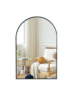 an arch shaped mirror in the corner of a room