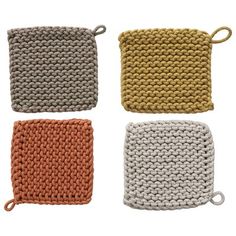 four crocheted dishcloths are shown in three different colors and one has a knot on the end